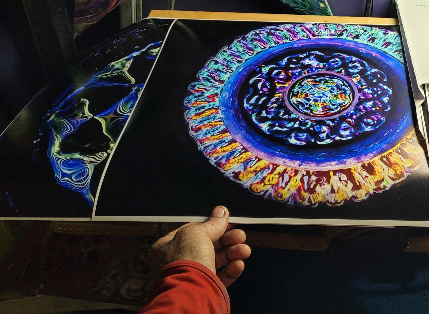 Fresh prints straight off the press, held for scale